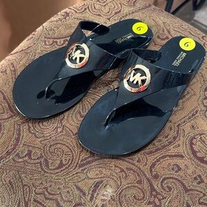 NWT Michael Kors Glossy Black Flip Flops with Gold Emblem
